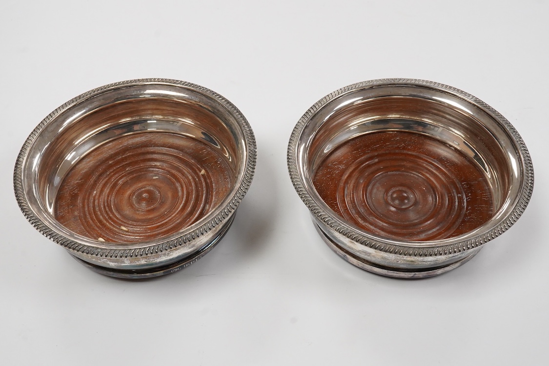A pair of Elizabeth II silver mounted wine coasters, by C.J. Vander Ltd, London, 1961, overall diameter 15cm.